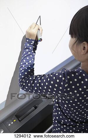 Girl drawing on projection screen in classroom View Large Photo Image Stock Image - Girl drawing on projection screen in classroom. Fotosearch