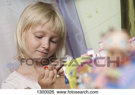 Stock Photograph - Girl playing with toys. Fotosearch