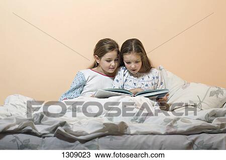 Girls reading story book View Large Photo Image Stock Image - Girls reading story book. Fotosearch