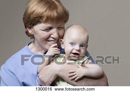 Grandmother playing with grandson, close-up View Large Photo Image Stock Photograph - Grandmother playing with grandson, close-up. Fotosearch