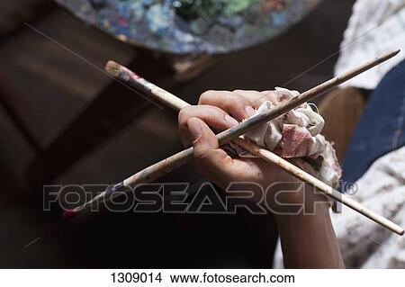 Human hand holding paintbrush, close-up View Large Photo Image Picture - Human hand holding paintbrush, close-up. Fotosearch