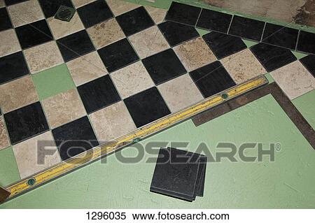 Installing floor tiles View Large Photo Image Stock Photography - Installing floor tiles. Fotosearch