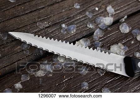 Kitchen knife and fish scaly on chopping board, close-up View Large Photo Image Stock Photo - Kitchen knife and fish scaly on chopping board, close-up. Fotosearch