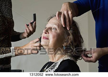 Makeup artist applying compact powder on woman face View Large Photo Image Stock Image - Makeup artist applying compact powder on woman face. Fotosearch