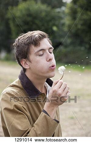 Man blowing dandelion and making wish View Large Photo Image Picture - Man blowing dandelion and making wish. Fotosearch