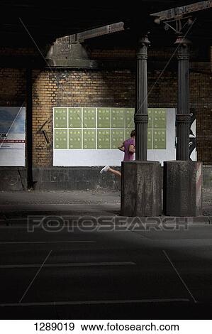 Stock Photo - Man jogging on footpath. Fotosearch