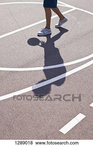 Man playing basketball, low section View Large Photo Image Stock Photo - Man playing basketball, low section. Fotosearch