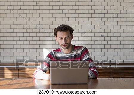 Stock Photo - Man using laptop. Fotosearch