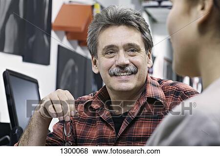 Mature man talking with woman, smiling View Large Photo Image Stock Photo - Mature man talking with woman, smiling. Fotosearch