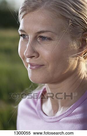Stock Photography - Mature woman looking away, close-up. Fotosearch