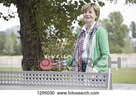 Mature woman playing table tennis View Large Photo Image Stock Image - Mature woman playing table tennis. Fotosearch