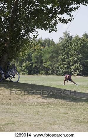 Mid adult man exercising in park View Large Photo Image Picture - Mid adult man exercising in park. Fotosearch