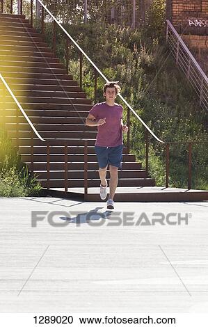 Mid adult man jogging View Large Photo Image Stock Image - Mid adult man jogging. Fotosearch