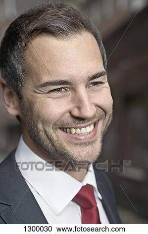 Mid adult man looking away and smiling, close-up View Large Photo Image Stock Image - Mid adult man looking away and smiling, close-up. Fotosearch