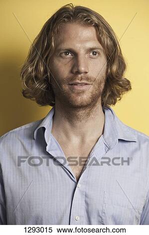 Stock Photography - Mid adult man looking away, close-up. Fotosearch