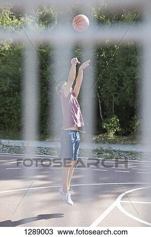 Mid adult man playing basketball View Large Photo Image Stock Image - Mid adult man playing basketball. Fotosearch