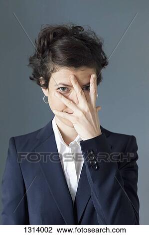 Mid adult woman covering her eyes in embarrassment View Large Photo Image Stock Image - Mid adult woman covering her eyes in embarrassment. Fotosearch