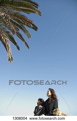 Picture - Mother and daughter looking away with expressions of surprise. Fotosearch