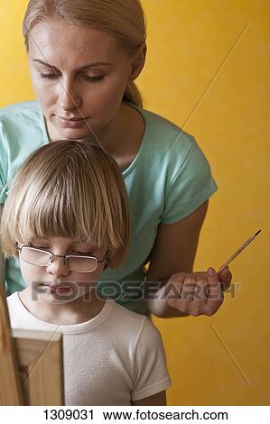 Mother and son painting on easel View Large Photo Image Stock Image - Mother and son painting on easel. Fotosearch