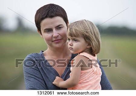 Mother holding daughter View Large Photo Image Stock Image - Mother holding daughter. Fotosearch
