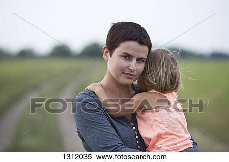 Stock Photography - Mother holding daughter. Fotosearch