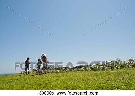 Stock Photography - Mother walking with daughter and son. Fotosearch