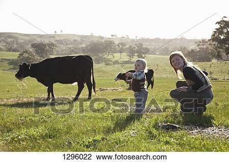 Stock Image - Mother with baby boy, looking away. Fotosearch