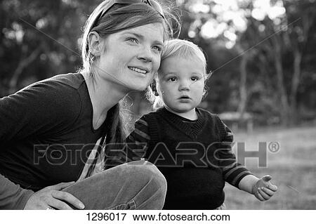 Mother with baby boy, looking away View Large Photo Image Stock Photo - Mother with baby boy, looking away. Fotosearch