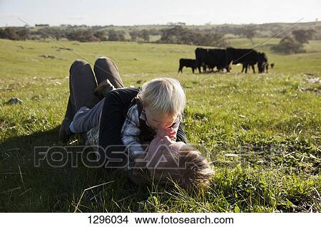 Picture - Mother with baby boy lying on grass. Fotosearch