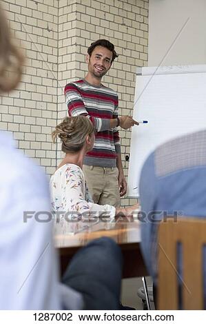 Stock Image - Office colleagues in boardroom meeting. Fotosearch