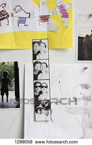 Stock Photo - Photos and drawings on wall. Fotosearch