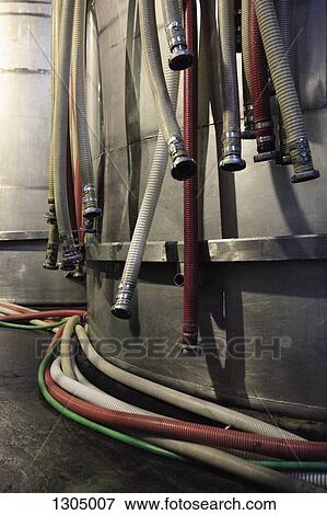 Pipes with connectors hanging on water tank View Large Photo Image Stock Photo - Pipes with connectors hanging on water tank. Fotosearch