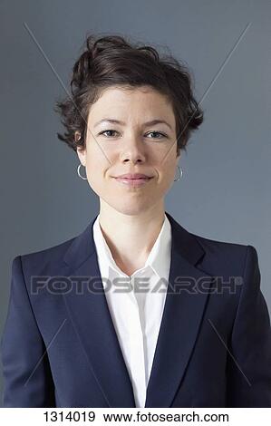 Stock Photo - Portrait of a confident mid adult woman smiling, close-up. Fotosearch