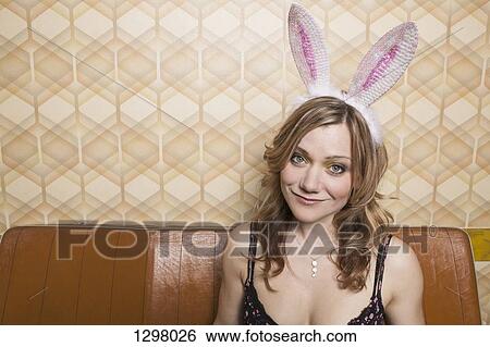 Portrait of a woman with rabbit ears, smiling View Large Photo Image Stock Photograph - Portrait of a woman with rabbit ears, smiling. Fotosearch