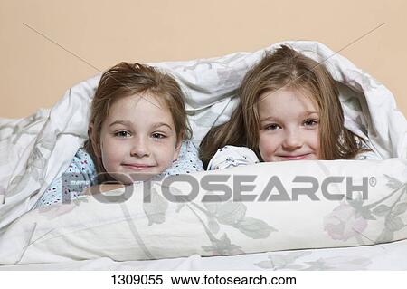 Portrait of girls relaxing on bed View Large Photo Image Stock Photography - Portrait of girls relaxing on bed. Fotosearch