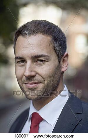 Stock Image - Portrait of mid adult man smiling, close-up. Fotosearch