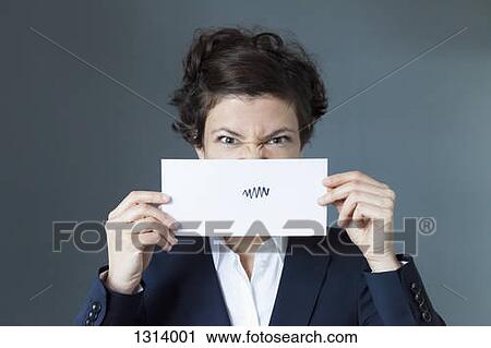 Stock Image - Portrait of mid adult woman holding paper with zigzag sign, close-up. Fotosearch