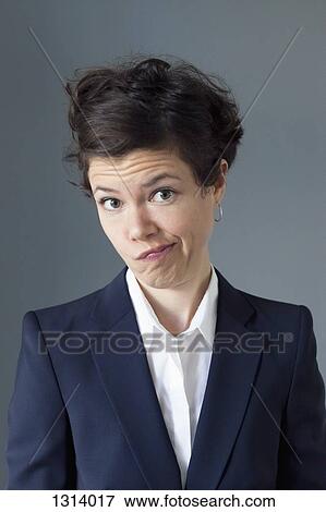 Stock Photo - Portrait of mid adult woman making funny face, close-up. Fotosearch