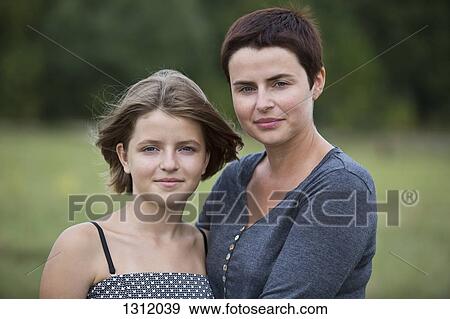 Stock Photo - Portrait of mother and daughter, close-up. Fotosearch
