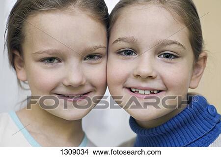 Portrait of two girls smiling, close-up View Large Photo Image Picture - Portrait of two girls smiling, close-up. Fotosearch