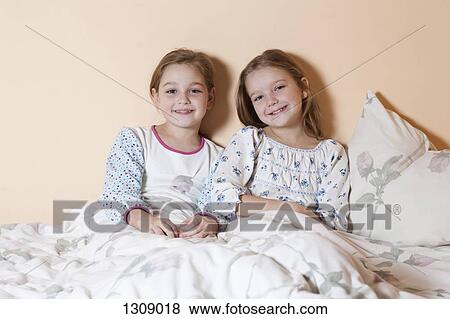 Portrait of two girls smiling, close-up View Large Photo Image Stock Photo - Portrait of two girls smiling, close-up. Fotosearch