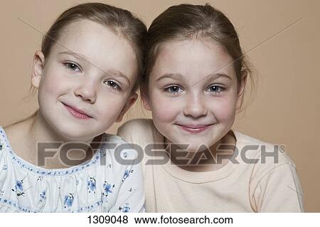 Portrait of two girls smiling, close-up View Large Photo Image Stock Photo - Portrait of two girls smiling, close-up. Fotosearch
