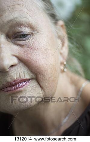 Senior woman looking down, close-up View Large Photo Image Picture - Senior woman looking down, close-up. Fotosearch