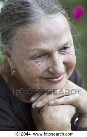 Picture - Senior woman looking down, close-up. Fotosearch