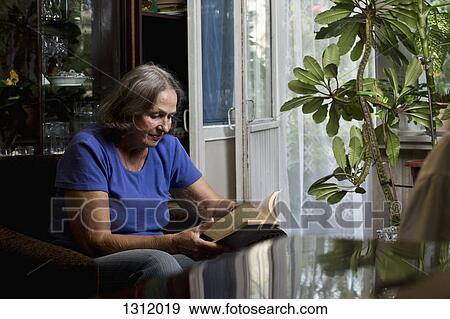 Senior woman reading book View Large Photo Image Stock Photo - Senior woman reading book. Fotosearch