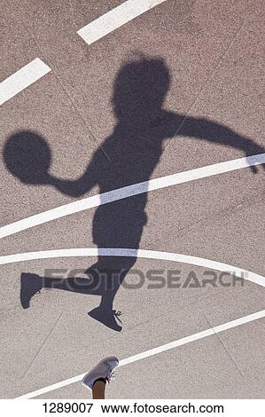 Shadow of man Playing basketball View Large Photo Image Stock Photo - Shadow of man Playing basketball. Fotosearch