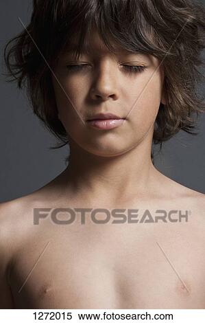 Stock Photography - Shirtless boy with eyes closed, close-up. Fotosearch