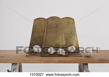 Snail shells and pieces of metal on wooden workbench View Large Photo Image Stock Photo - Snail shells and pieces of metal on wooden workbench. Fotosearch