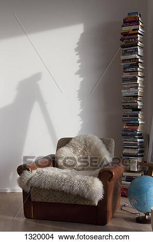 Stack of books and armchair in study View Large Photo Image Picture - Stack of books and armchair in study. Fotosearch