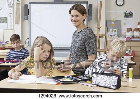 Teacher with students in classroom View Large Photo Image Stock Photo - Teacher with students in classroom. Fotosearch
